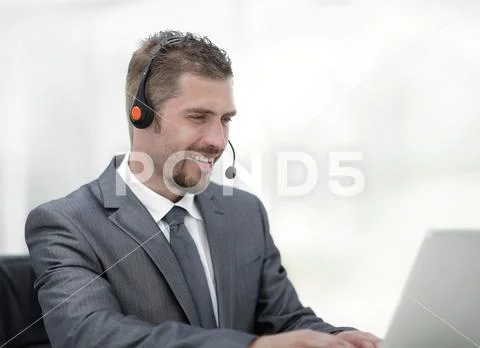 Young agent of the call center with the headphones. Stock Photos