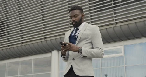 Young Aggressive Afro American using his Mobile Phone. Typing with Power on Stock Footage 115214126