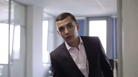 Young aggressive man looking into the camera, saying and showing a fist. Stock Footage 70424775