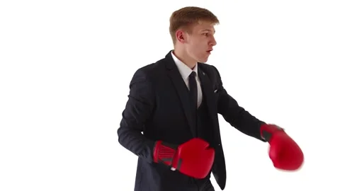 A young, aggressive office worker unfolds in profile and box in a classic suit Stock Footage 134330117