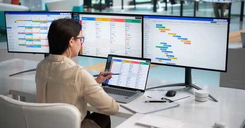 Young Agile Project Manager Updates Task List On Laptop Using Scrum Board. Stock Photos
