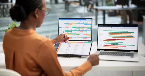 Young Agile Project Manager Uses Laptop And Digital Calendar To Organize Task Stock Photos