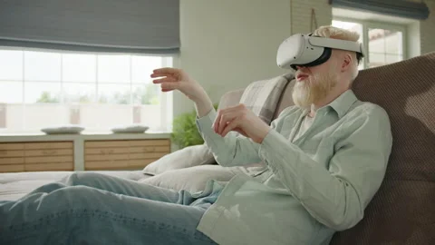 Young albino man using VR headset, entertaining himself in digital world Stock Footage 244847823