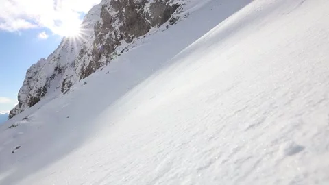 Young alpinist runs down fast from the snow summit Stock Footage 239344587