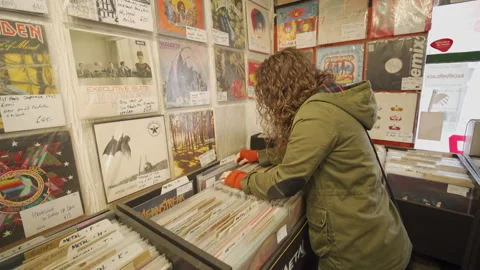 Young Alternative Anonymous Female Browsing Vinyl Records. Stock-Footage 136607205