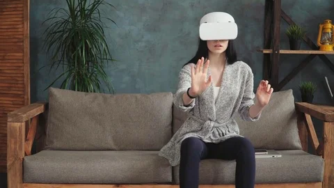 Young amazed woman using virtual reality glasses Stock Footage 84944622