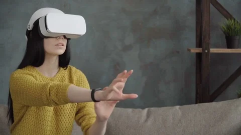 Young amazed woman using  vr glasses at home Stock Footage 74954612
