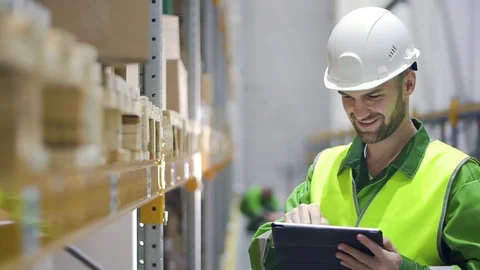 Young american man worker is using tablet while working day at modern warehouse. Stock Footage 127674137