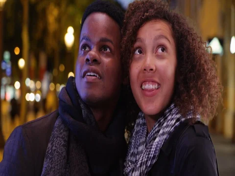 Young and affectionate black couple sightseeing on the Champs-Elysees at night Stock Footage 85007343