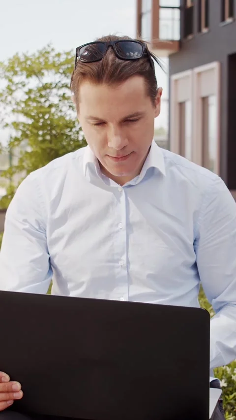 Young and attractive freelancer working outdoor. Office worker or businessperson Stock Footage 308480993