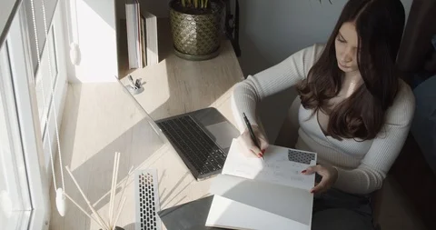 A young and beautiful lady,  notes the creative ideas in the notebook. Stock Footage 127283924