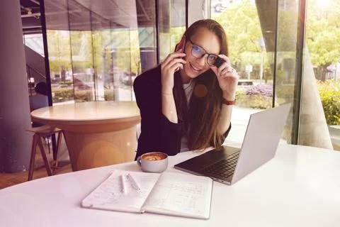 Young and cheerful girl working on a laptop Stock Photos