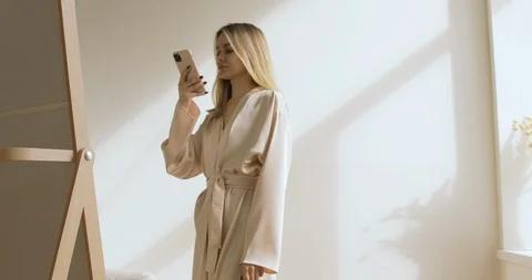 Young And Cute Blonde Looking In The Mirror, The Lady Is Taking Photos Stock Footage 126030160