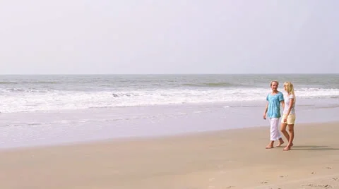 Young and cute couple joy on the beach. Honeymoon near ocean. Video stock 26243723