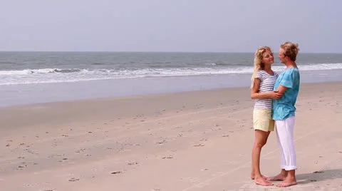 Young and cute couple joy on the beach. Honeymoon near ocean. Video stock 26243780