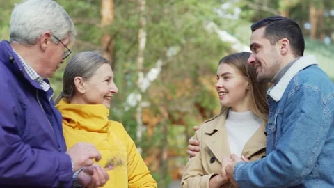 Young and eldelry couples talking in countryside Stock Footage 142487024