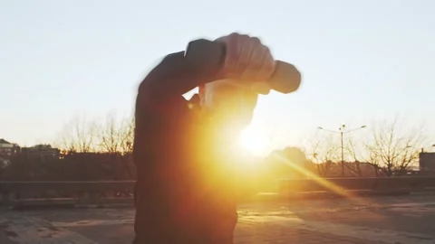Young and fit man having evening workout outdoor. Urban sunset background Stock Footage 137659440