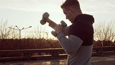 Young and fit man having evening workout outdoor. Urban sunset background Stock Footage 142018640