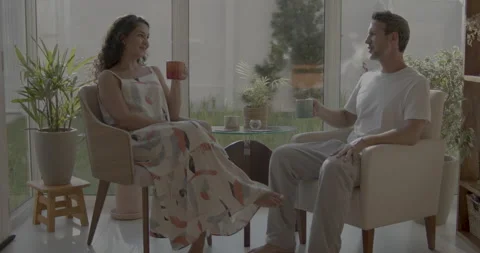 Young and friendly couple drinking coffee and talking. Stock Footage 232435500