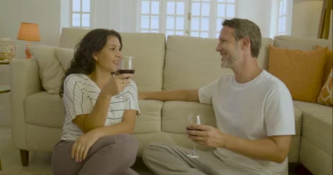 Young and friendly couple talk and have fun while drinking wine. Stock Footage 232433371