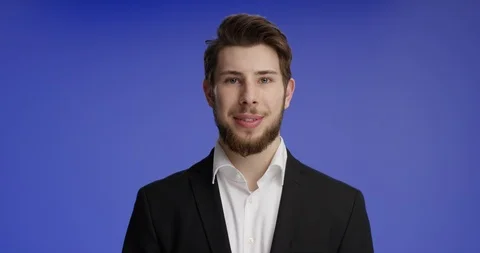 Young and good looking man smiling into the camera Stock Footage 99459799