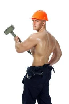 Young and handsome builder with a sledgehammer and sexy body Foto stock