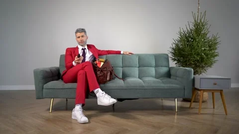 Young and handsome guy with a gray beard at home watching TV Stock Footage 167652469