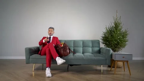 Young and handsome guy with a gray beard at home watching TV Video stock 167652558