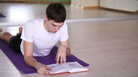 Young and handsome guy reading a book 3 Vídeo Stock 22180419
