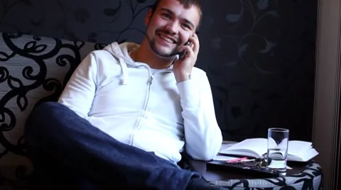 Young and happy guy talking by mobile phone Stock Footage