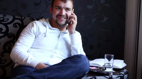 Young and happy guy talking by mobile phone Stock Footage 8552035