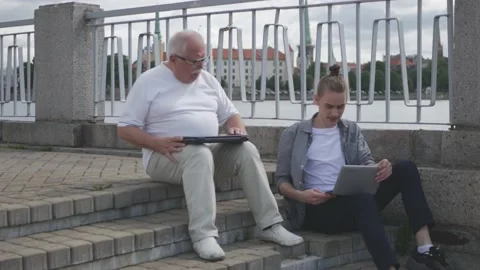 Young and old men sit on steps start working at handrails Video stock 147171909