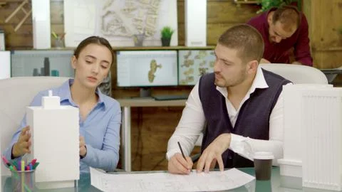 Young and talented architects changing the plans for a business buildings Fotos de archivo