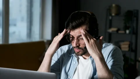 A young Angry Man Solves Problems Communicates Online with Friends or Clients Stock Footage 144372319