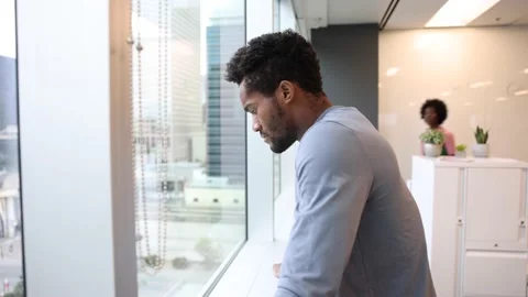 Young apprentice contemplating beside glass wall 스톡 동영상 221032392