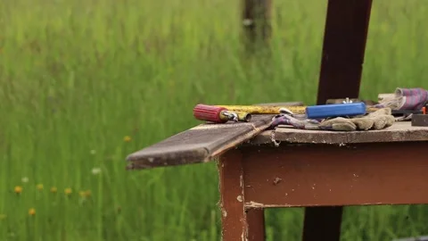 Young apprentice craftsman learns how to handle a hand saw Stock Footage 134288529