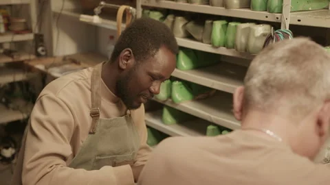 Young Apprentice Helping Shoemaker in Workshop Video stock 262526313