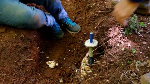 Young apprentice learnig how to drill rocks with a hammer and a driller. Stock Footage 109325963