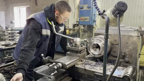 Young apprentice mastering the lathe machine in industrial workshop 스톡 동영상 272488483