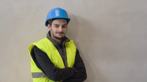 Young apprentice with security helmet, isolated on background Stock Footage 123215016