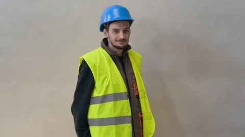 Young apprentice with security helmet, isolated on background Video stock 123215812