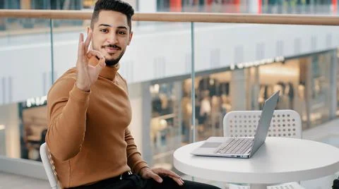 Young arab guy student freelancer typing on laptop surfing social network on Stock-Fotos