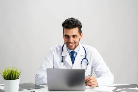 Young arab internist working at computer Stock Photos