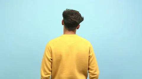 Young arab man from behind, looking back, paying attention and contemplating as Stock Footage 138665472
