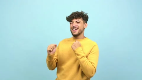 Young arab man dancing and having fun, moving arms listening to music Stock Footage 138665262