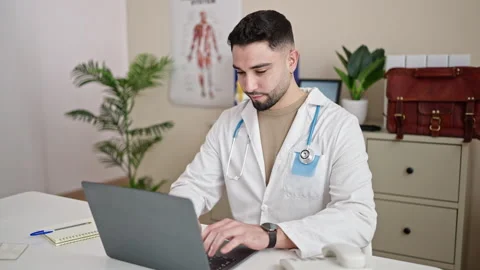 Young arab man doctor using laptop working at clinic Video stock 233420922