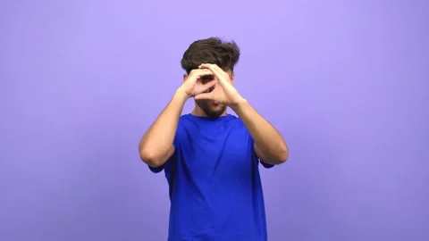 Young arab man doing the gesture of a spyglass, is observing something that is Stock Footage 138664682