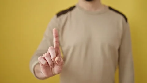 Young arab man saying no with finger over isolated yellow background Stock-Footage 233420733