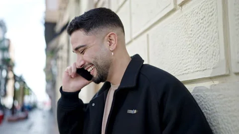 Young arab man smiling confident talking on the smartphone at street Video stock 233418426