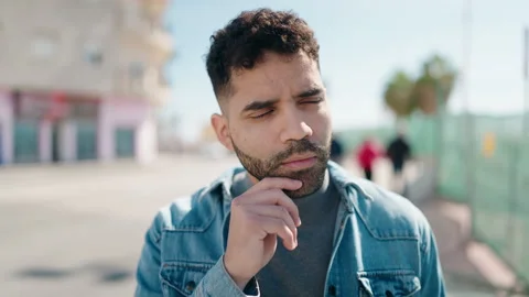 Young arab man standing with doubt expression at street Video stock 171791982